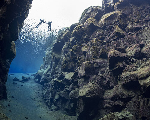 Four people inside a glacier in iceland.